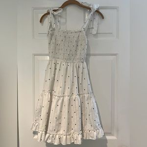 White dress with navy details.